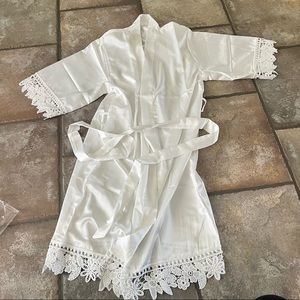 Kids silk robe. Never used. Has tiny little stain in the back.